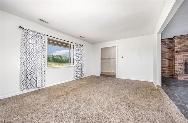 306 Pratt Rd, Dobson, NC 27017 - carpeted spare room with baseboards and a fireplace