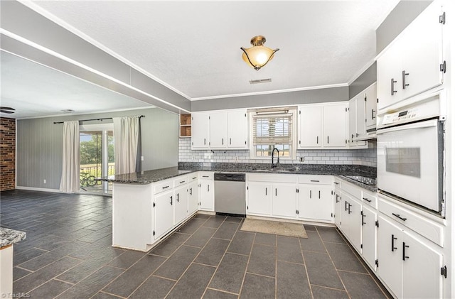 306 Pratt Rd, Dobson, NC 27017 - kitchen with stainless steel dishwasher, oven, a peninsula, decorative backsplash, and ornamental molding