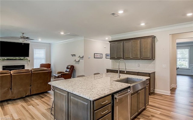 3609 Wesley Point Dr, Browns Summit, NC 27214 - kitchen with dishwasher, crown molding, light wood-style flooring, plenty of natural light, and recessed lighting