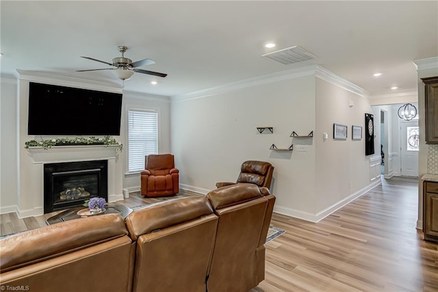 3609 Wesley Point Dr, Browns Summit, NC 27214 - living room featuring ornamental molding, ceiling fan, healthy amount of natural light, light wood-style flooring, and a glass covered fireplace