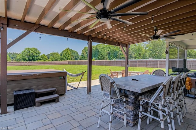 3609 Wesley Point Dr, Browns Summit, NC 27214 - fenced backyard with a hot tub, a patio, a ceiling fan, and view of scattered trees