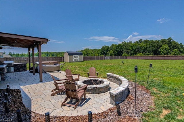 3609 Wesley Point Dr, Browns Summit, NC 27214 - fenced backyard with an outdoor fire pit, area for grilling, a storage shed, and a patio
