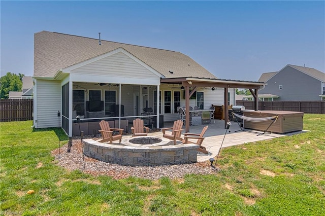 3609 Wesley Point Dr, Browns Summit, NC 27214 - rear view of property featuring a hot tub, a ceiling fan, a fire pit, a fenced backyard, and a patio