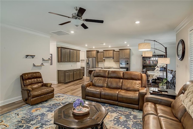 3609 Wesley Point Dr, Browns Summit, NC 27214 - living room featuring crown molding, a ceiling fan, light wood finished floors, and recessed lighting