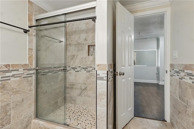 4624 Circle Dr, Winston-Salem, NC 27105 - full bathroom featuring a shower stall, tile walls, and ornamental molding