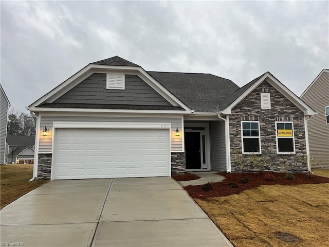 craftsman-style home featuring a garage and a front lawn