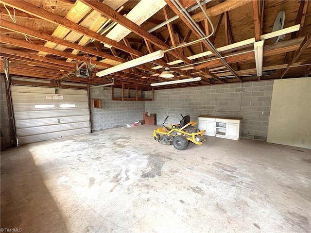 200 N 9th Ave, Mayodan, NC 27027 - garage featuring a garage door opener and concrete block wall