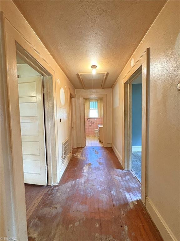 200 N 9th Ave, Mayodan, NC 27027 - hallway with attic access, hardwood / wood-style flooring, and a textured ceiling