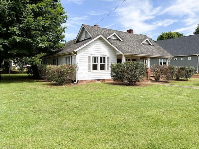 200 N 9th Ave, Mayodan, NC 27027 - view of front of property featuring a chimney, a front yard, a shingled roof, and covered porch