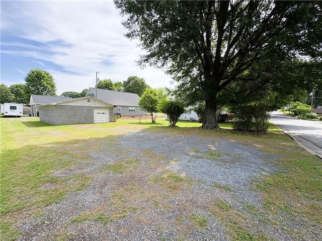 200 N 9th Ave, Mayodan, NC 27027 - view of green lawn with driveway and an attached garage