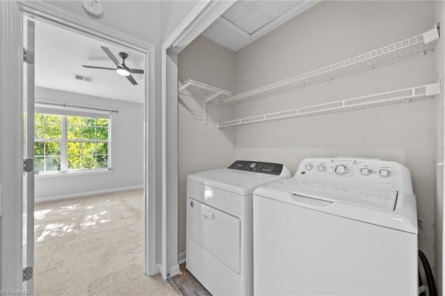 washroom featuring independent washer and dryer, a ceiling fan, baseboards, and light carpet