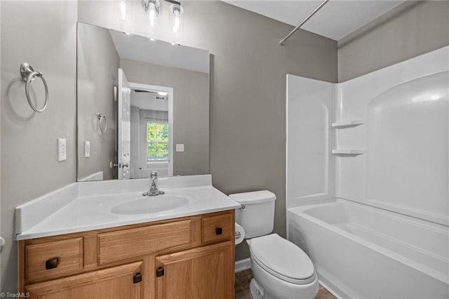 bathroom featuring toilet, vanity, and washtub / shower combination