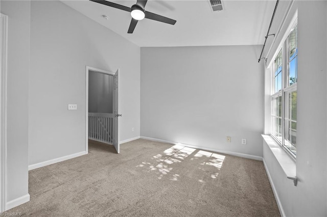unfurnished room featuring carpet, a ceiling fan, baseboards, and high vaulted ceiling