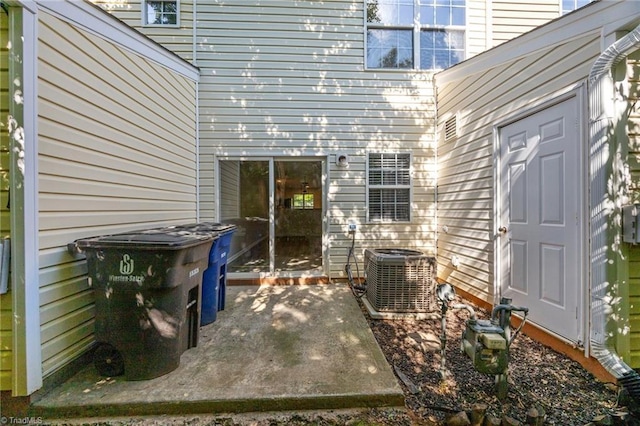 doorway to property featuring central AC and a patio area