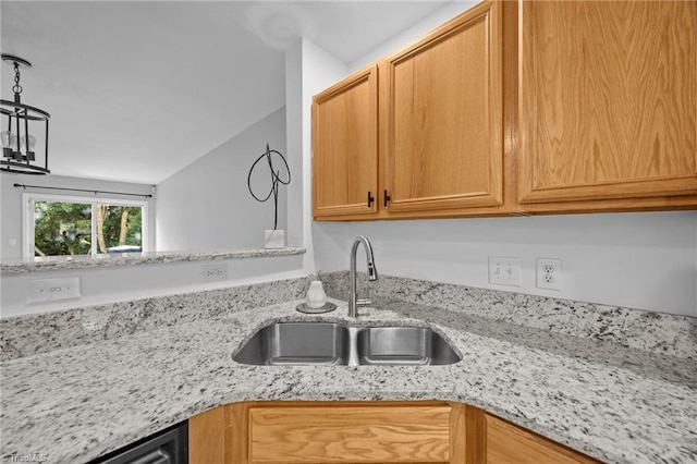 kitchen with a sink and light stone countertops