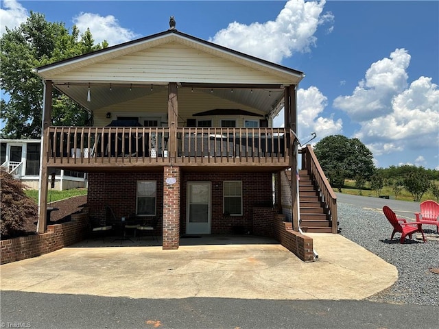 view of front of home with a patio and a wooden deck