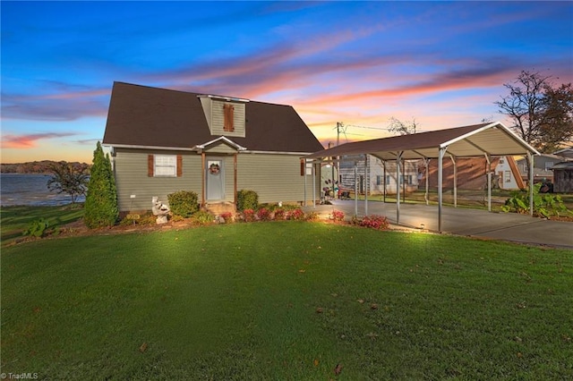 front facade with a lawn and a carport