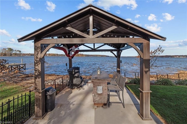 view of community with a gazebo, a yard, and a water view