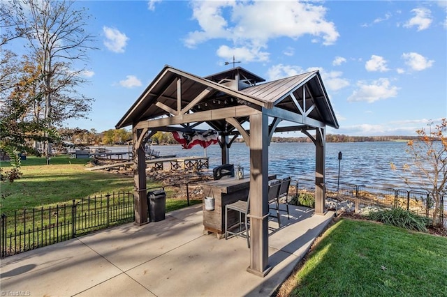 view of community featuring a gazebo, a patio, a water view, and a lawn