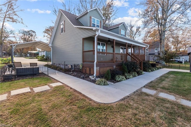 exterior space with a carport, a porch, and a front yard