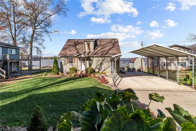 exterior space with a front yard, a water view, and a carport