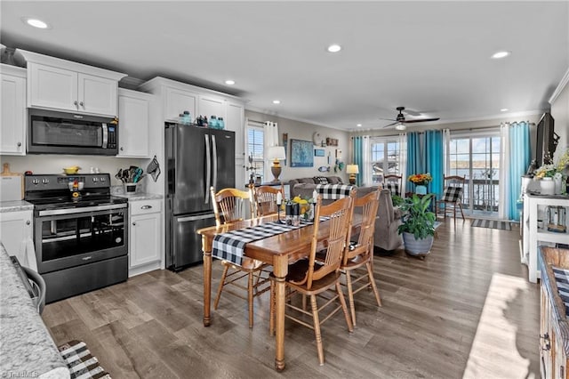 kitchen featuring white cabinets, appliances with stainless steel finishes, and light stone countertops