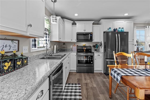 kitchen with stainless steel appliances, dark hardwood / wood-style floors, a healthy amount of sunlight, and sink