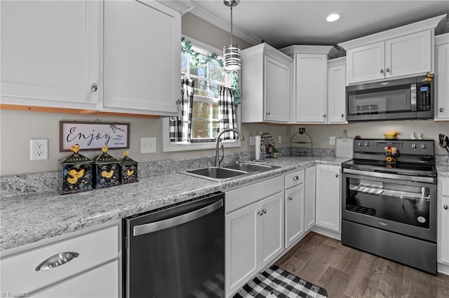 kitchen with appliances with stainless steel finishes, crown molding, sink, dark hardwood / wood-style floors, and white cabinetry