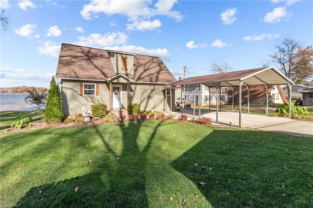 view of front facade with a carport, a water view, and a front yard