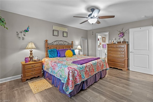 bedroom featuring ensuite bathroom, hardwood / wood-style floors, and ceiling fan