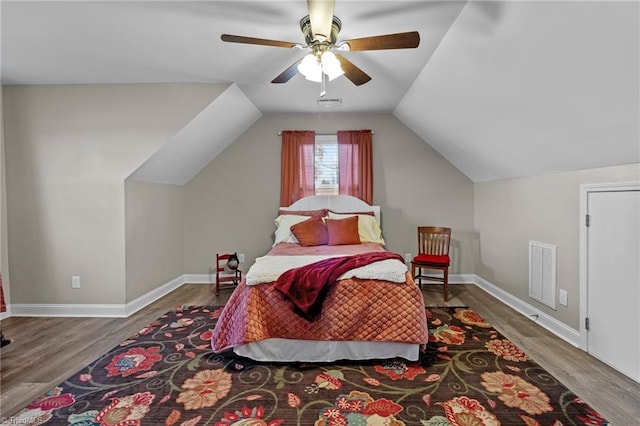 bedroom featuring ceiling fan, wood-type flooring, and lofted ceiling