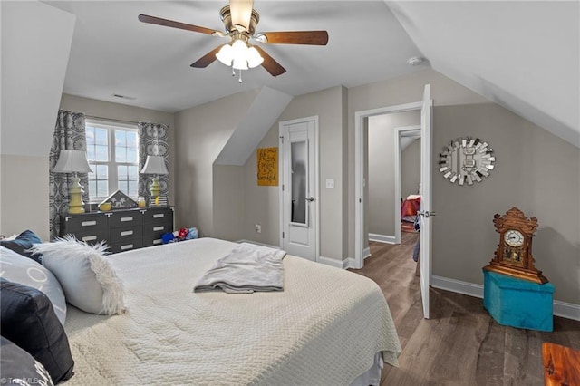 bedroom with vaulted ceiling, ceiling fan, and dark hardwood / wood-style floors