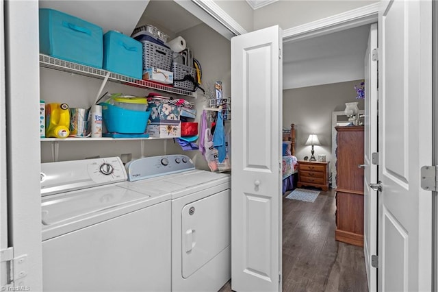 clothes washing area with washer and clothes dryer and dark hardwood / wood-style floors