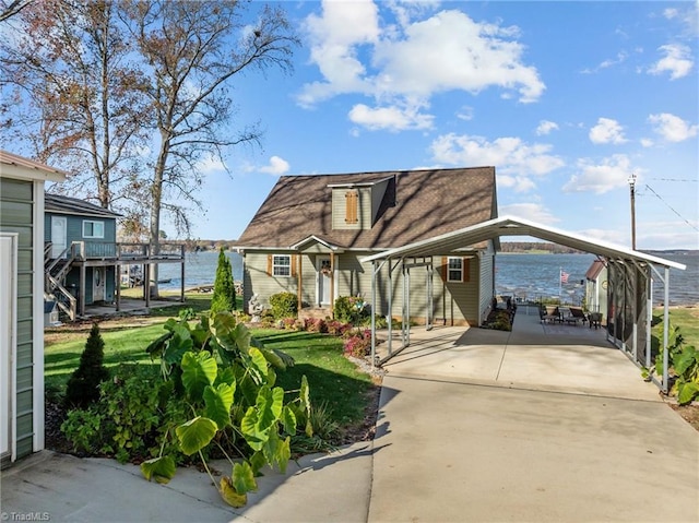 view of front of home featuring a water view, a front yard, and a carport