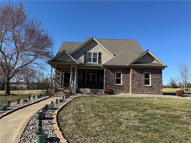 view of front of property with stone siding and a front yard