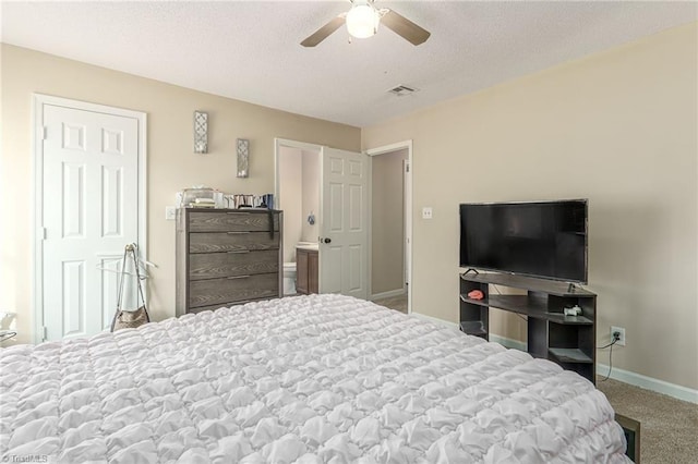 bedroom with baseboards, visible vents, a ceiling fan, a textured ceiling, and carpet floors