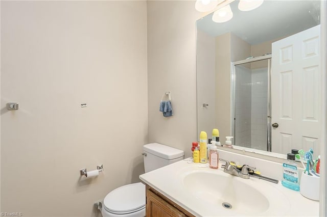 bathroom with vanity, an enclosed shower, and toilet