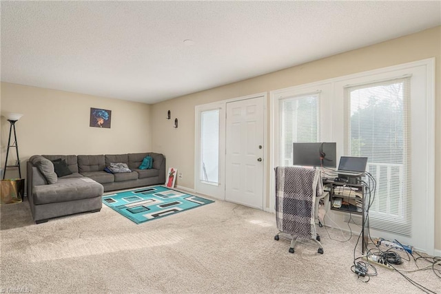 living room featuring carpet flooring, a textured ceiling, and baseboards