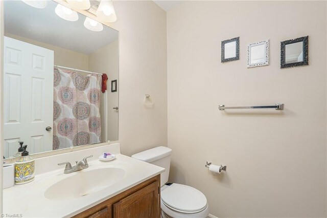 bathroom with vanity, toilet, and a shower with curtain