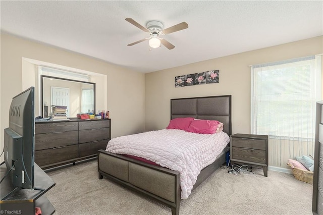 bedroom featuring ceiling fan and light colored carpet