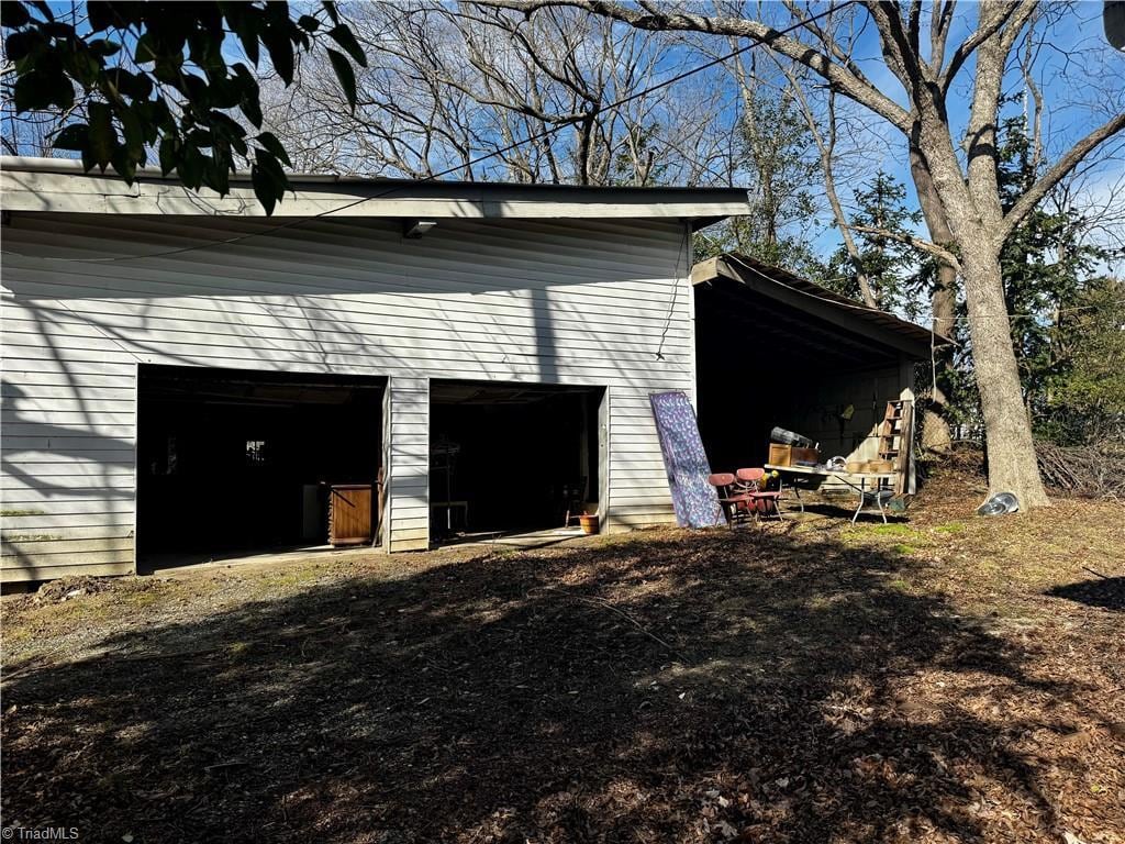 view of outdoor structure featuring a garage and an outbuilding