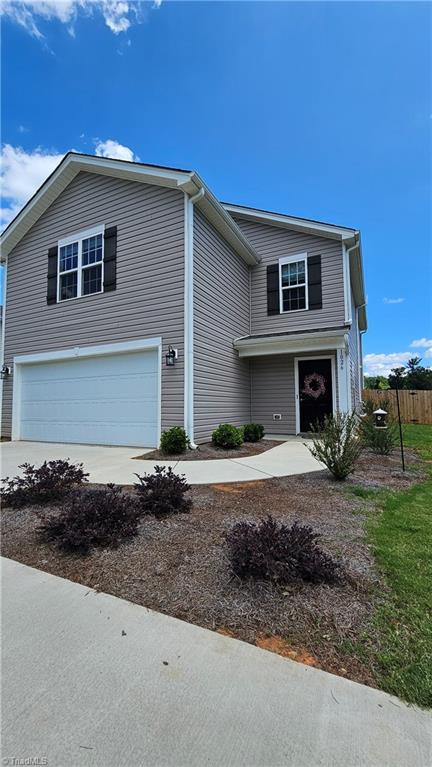 1026 Baileys Chapel Rd, Advance, NC 27006 - traditional-style house with a garage and concrete driveway