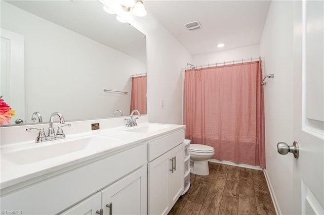 1026 Baileys Chapel Rd, Advance, NC 27006 - bathroom featuring wood-type flooring, double vanity, and recessed lighting
