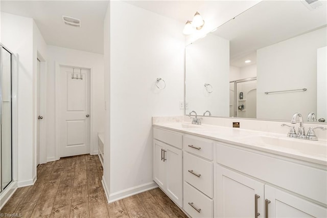 1026 Baileys Chapel Rd, Advance, NC 27006 - bathroom with double vanity, a shower with shower door, wood finished floors, and a tub to relax in