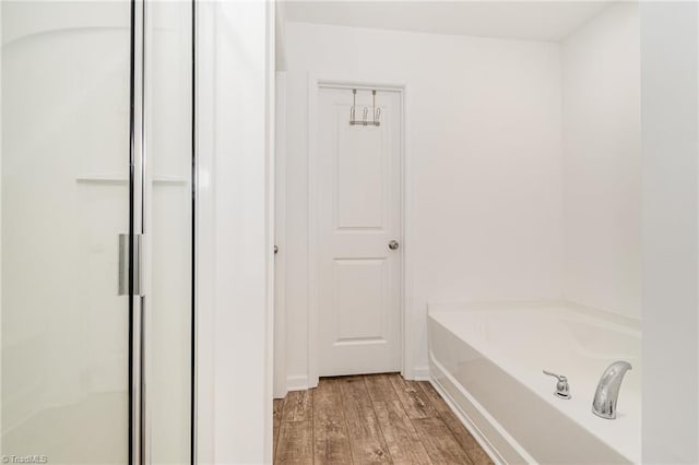 1026 Baileys Chapel Rd, Advance, NC 27006 - bathroom with wood finished floors, a shower stall, and a garden tub