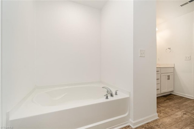1026 Baileys Chapel Rd, Advance, NC 27006 - full bath featuring vanity, wood finished floors, and a garden tub