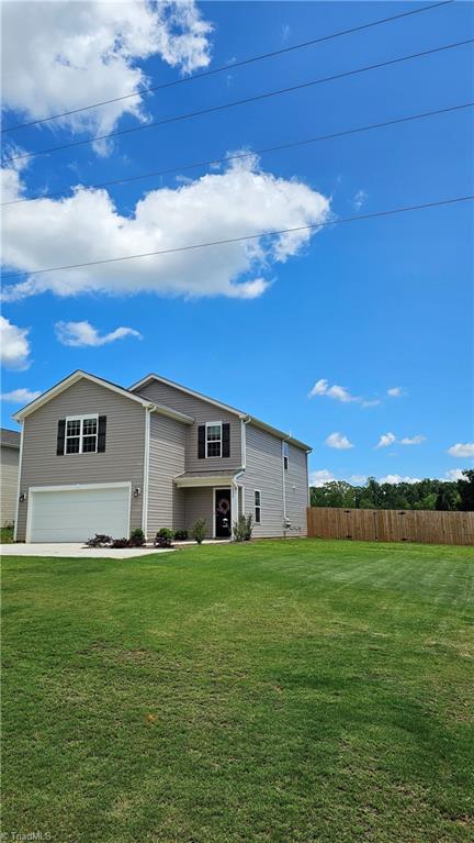 1026 Baileys Chapel Rd, Advance, NC 27006 - rear view of property featuring an attached garage