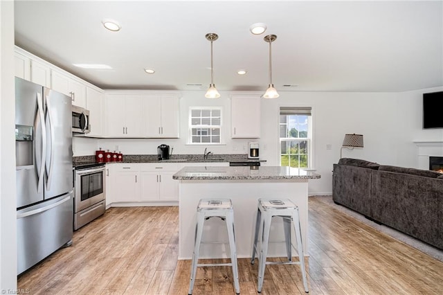1026 Baileys Chapel Rd, Advance, NC 27006 - kitchen featuring stainless steel appliances, open floor plan, white cabinets, and recessed lighting