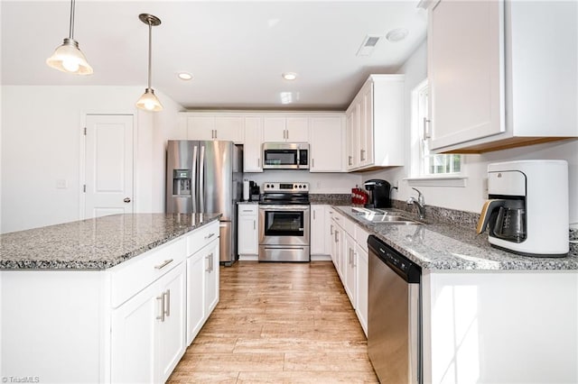 1026 Baileys Chapel Rd, Advance, NC 27006 - kitchen with stainless steel appliances, white cabinetry, light wood-style floors, stone countertops, and recessed lighting