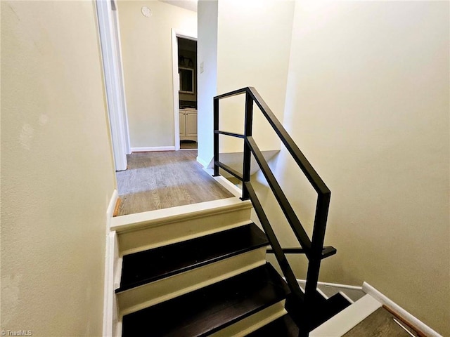 stairway featuring hardwood / wood-style flooring